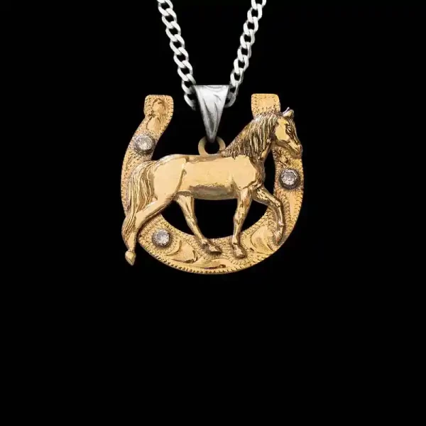 Do you hear that? The Lucky Horseshoe Pendant is callin’ your name! This piece is crafted in Jeweler’s Bronze with a stone-adorned horse-shoe base. Choose a figure and customize it to your liking! 1.5""x1.5"